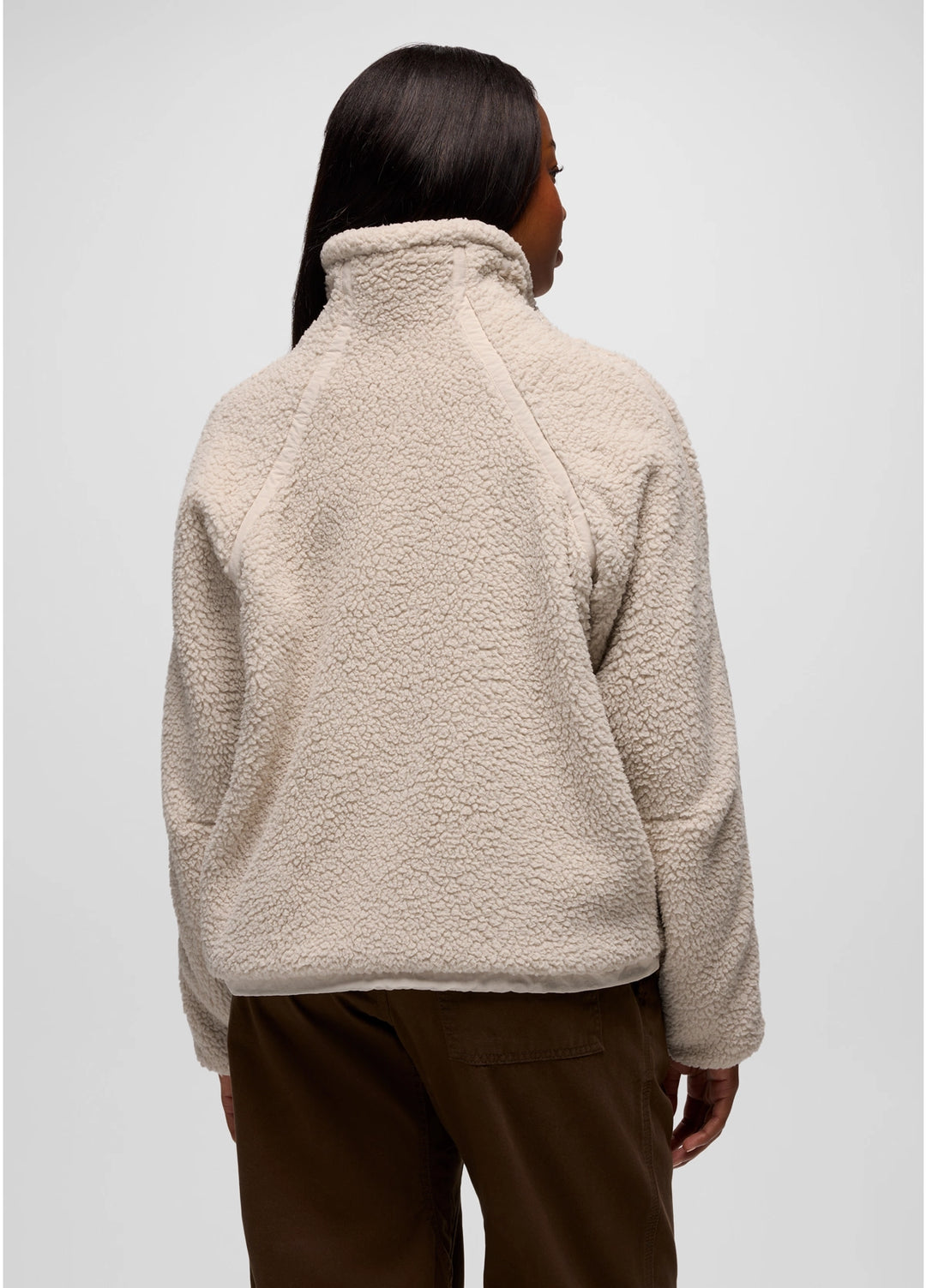 Person wearing a beige prAna Encinitas Fleece Jacket on a plain background