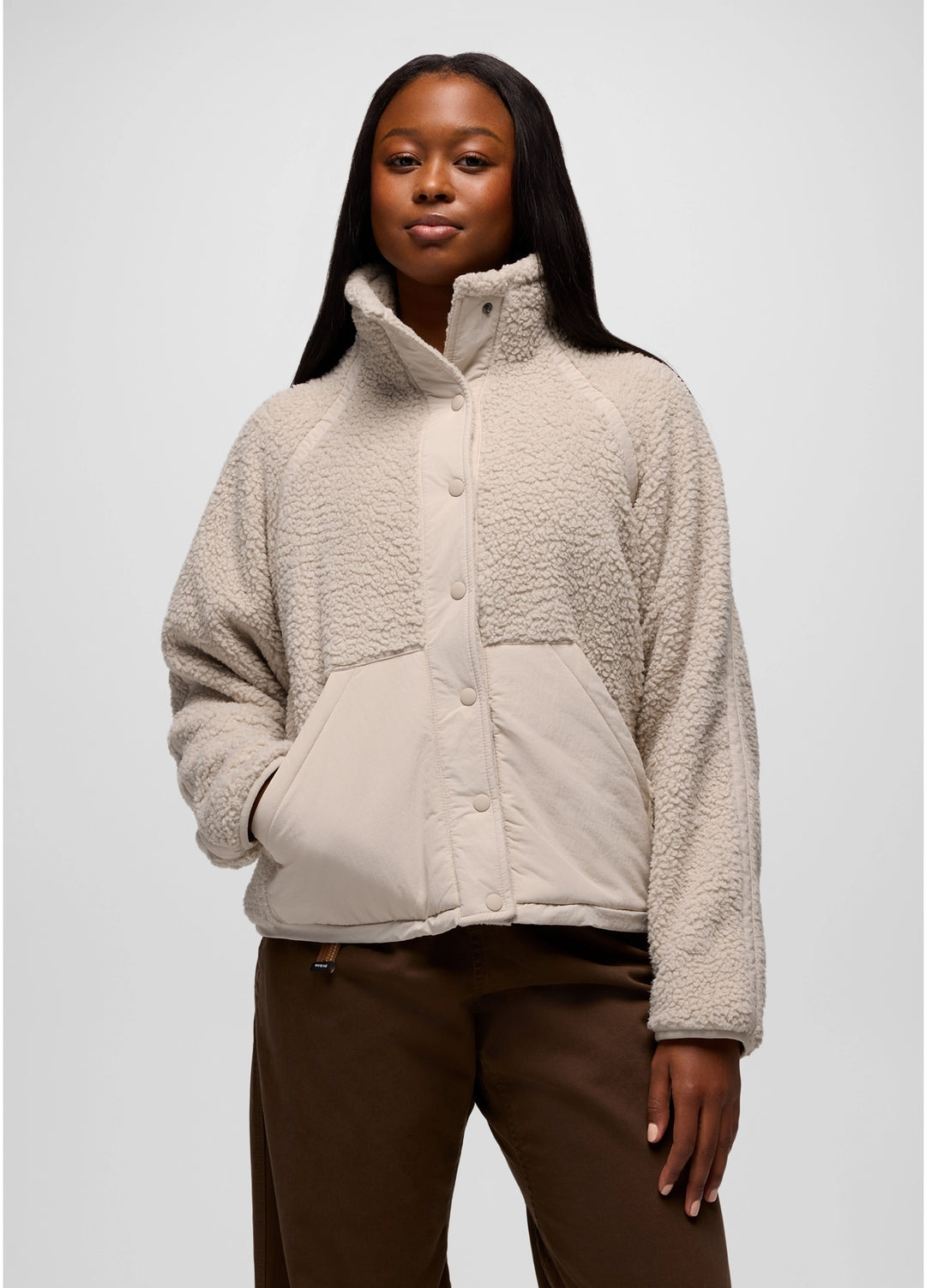 Woman wearing a beige prAna Encinitas Fleece Jacket against a white background