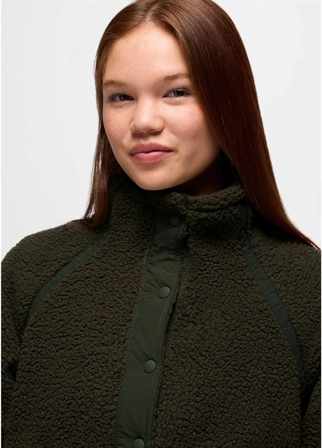 Person wearing a dark green prAna Encinitas Fleece Jacket on a light gray background