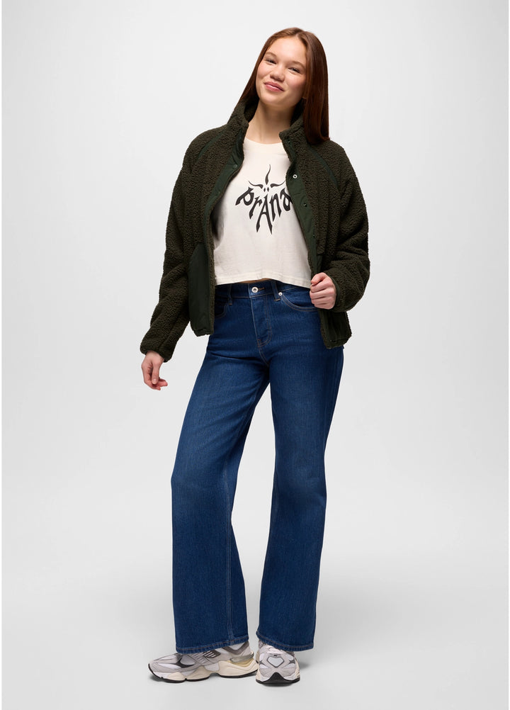 Person wearing a green prAna Encinitas Fleece Jacket, white t-shirt with text, and blue jeans on a white background
