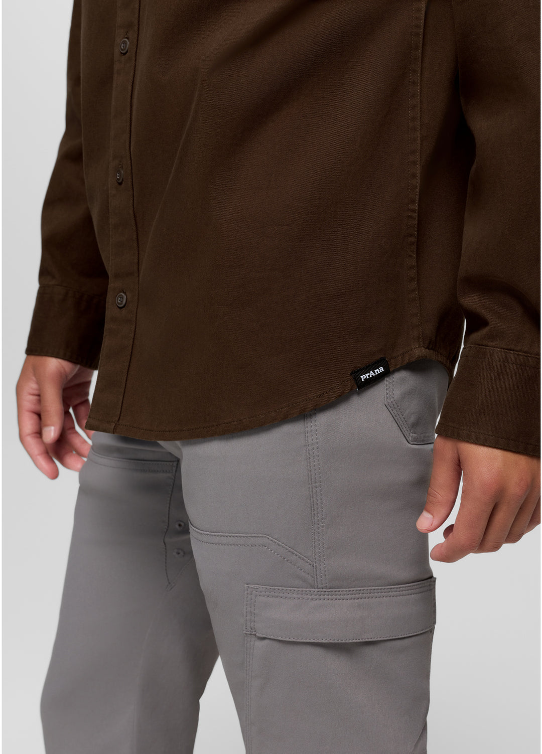 Brown shirt and gray pants on a plain background