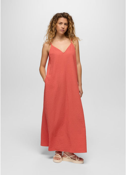 Woman wearing a coral dress on a white background