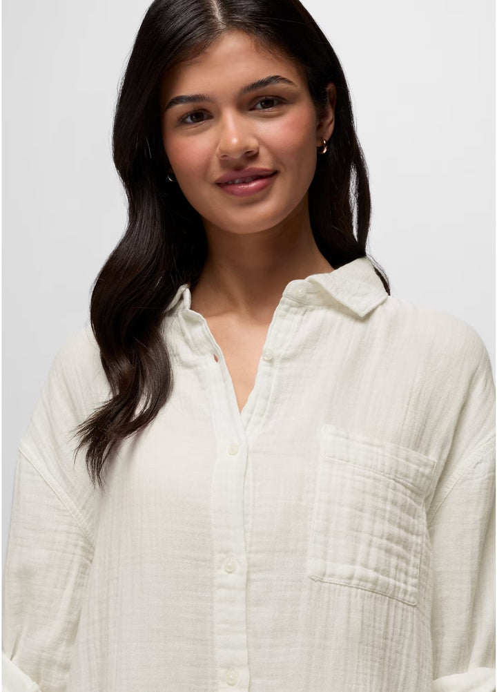 Woman wearing a white textured shirt against a plain background
