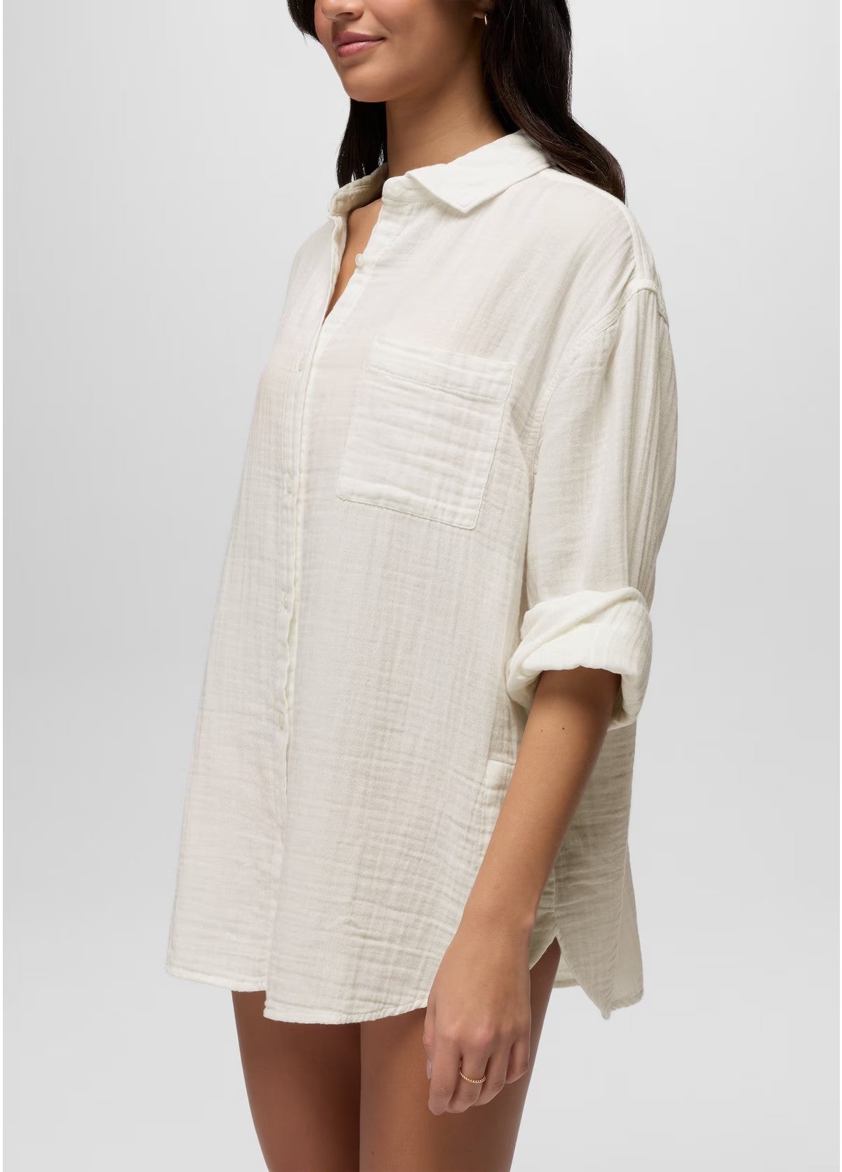 Woman wearing a white textured shirt against a plain background