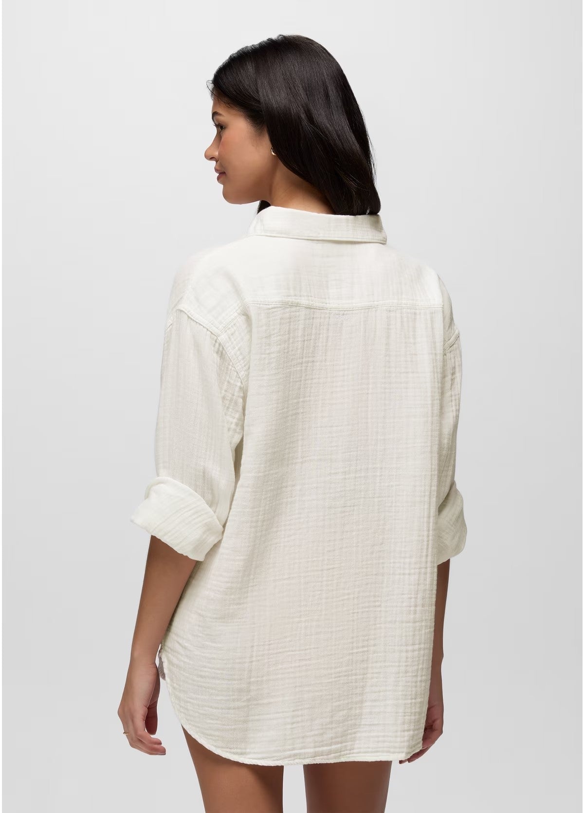 Woman wearing a white textured shirt on a plain background