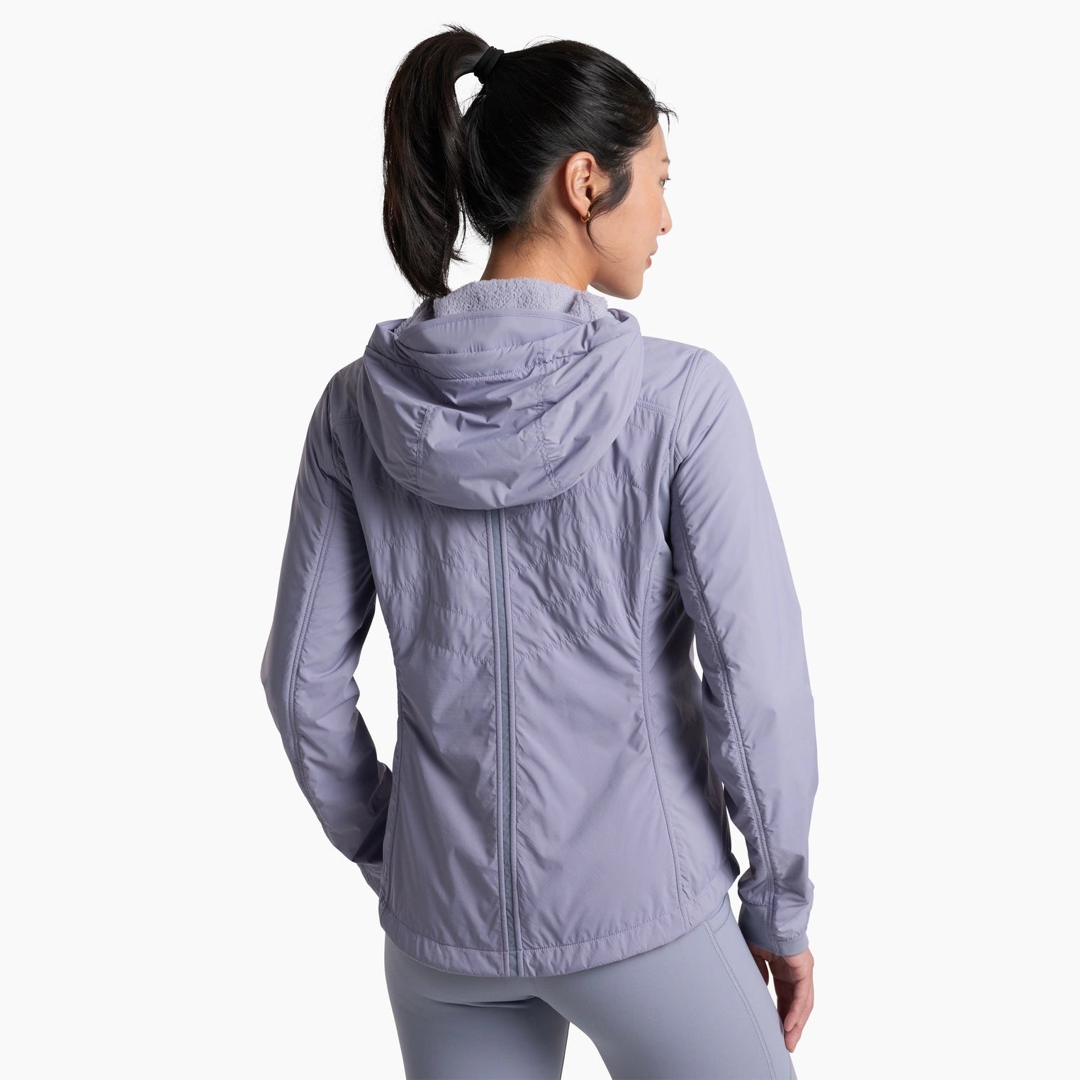 Woman wearing a light gray jacket on a white background