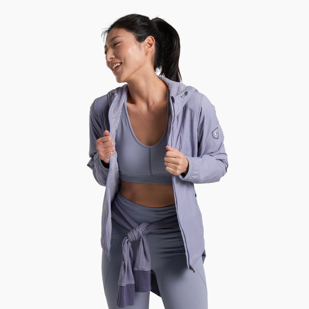 Woman wearing a light purple athletic jacket and pants on a white background