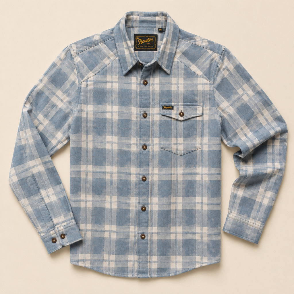 A light blue and white plaid western-style button-down shirt by Hamilton, featuring a chest flap pocket and dark brown buttons, laid flat against a light beige background.