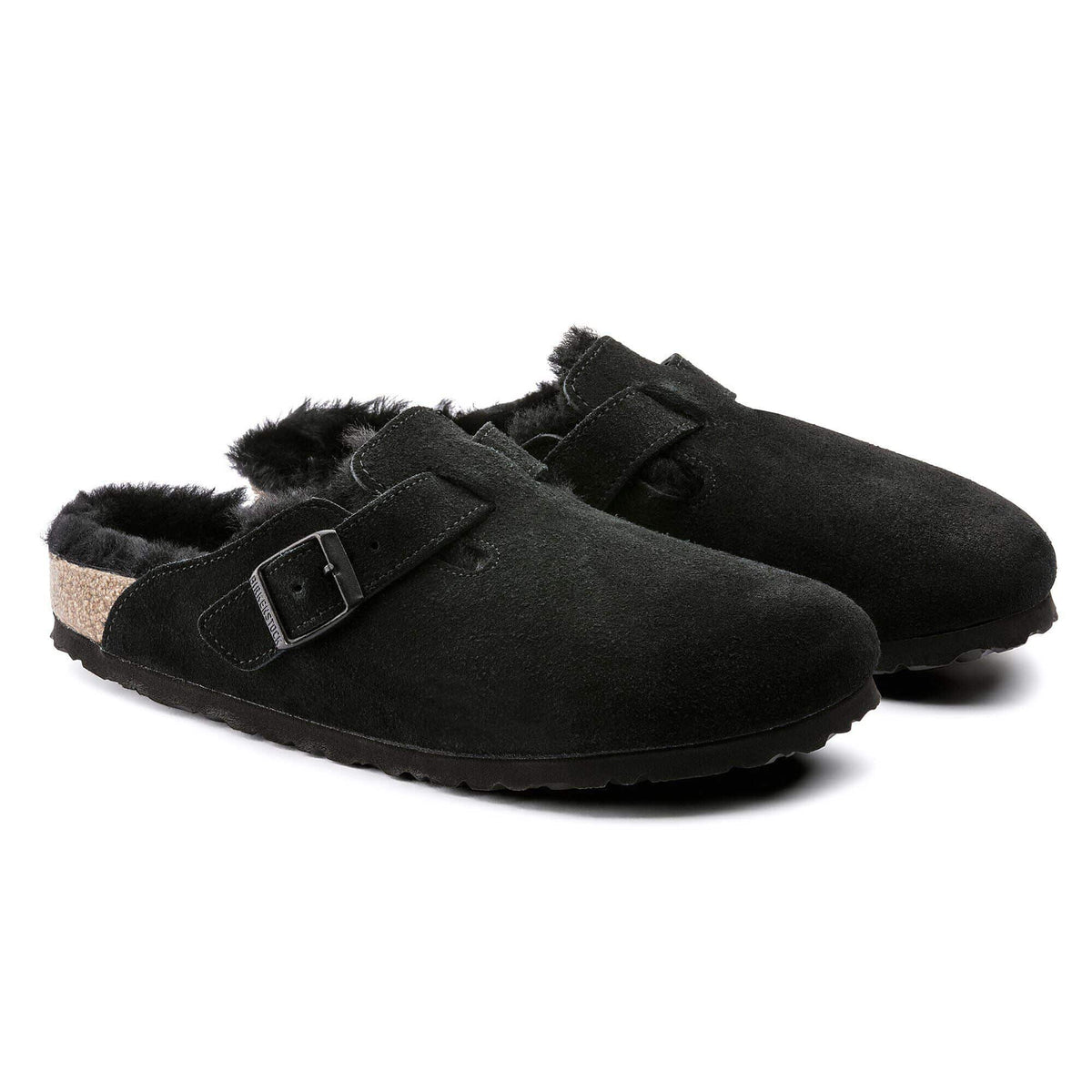Black slippers with fur lining on a white background