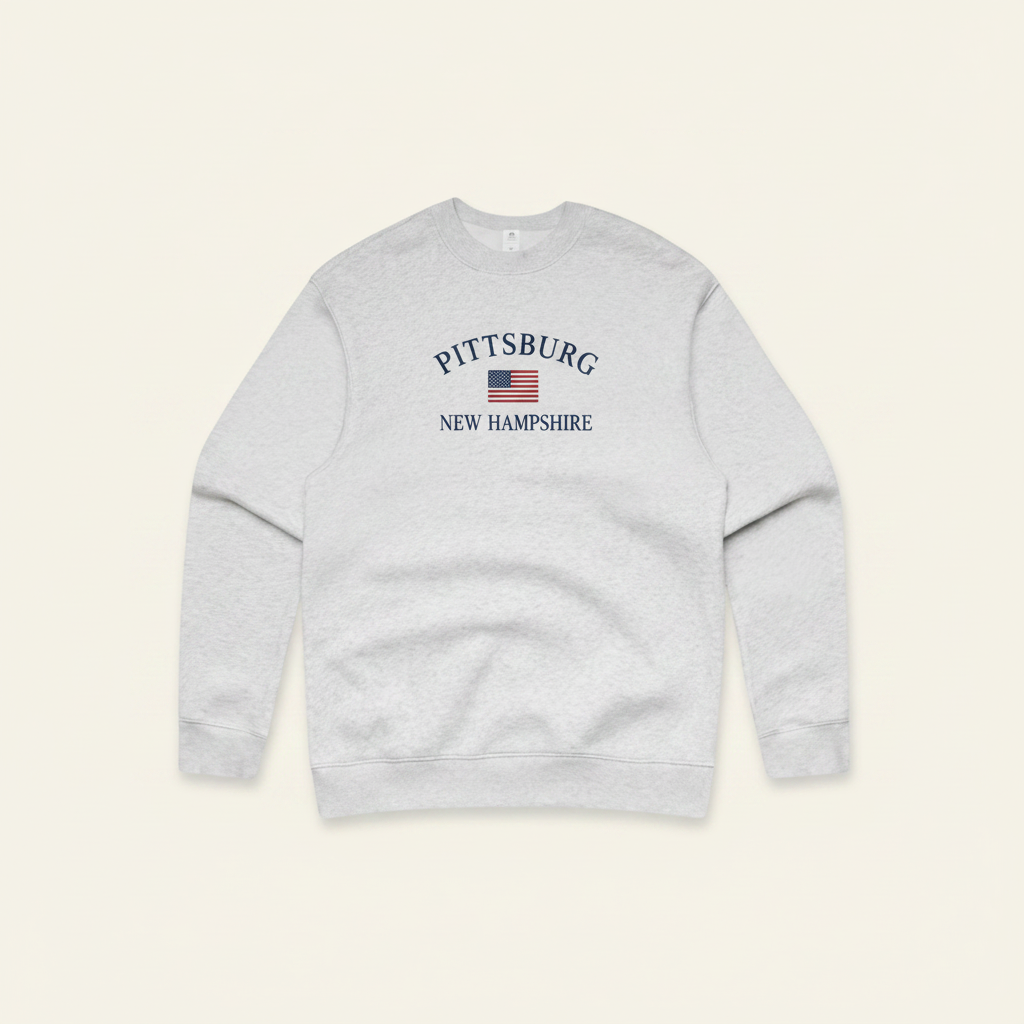 A light gray crewneck sweatshirt with a 'Pittsburg New Hampshire' graphic printed on the chest, displayed against a solid white background.