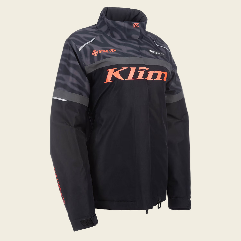 Black jacket with orange 'Klim' logo on a white background