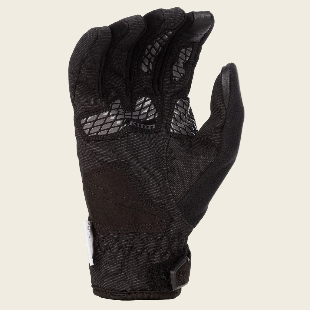 Black glove with textured palm on a white background