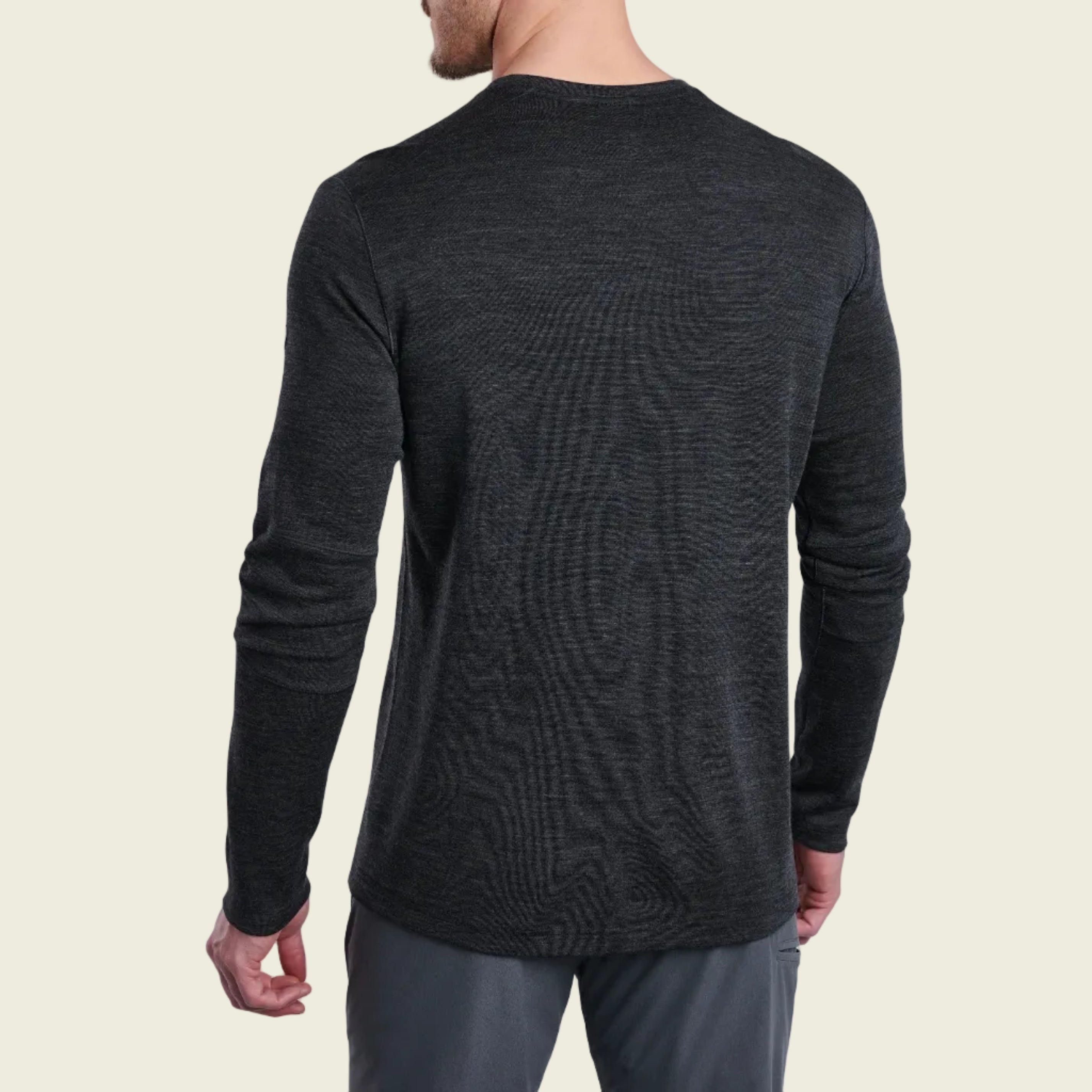 Person wearing a dark gray long-sleeve shirt on a white background