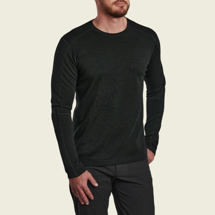 Man wearing a black long-sleeve shirt and pants on a white background