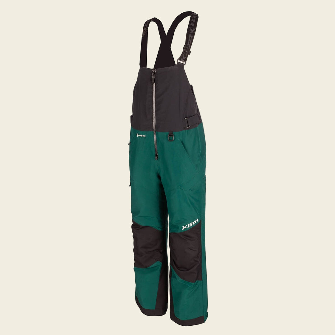 Green and black bib overalls with suspenders on a white background