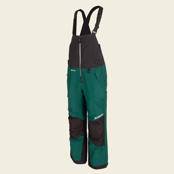 Green and black bib overalls with suspenders on a white background