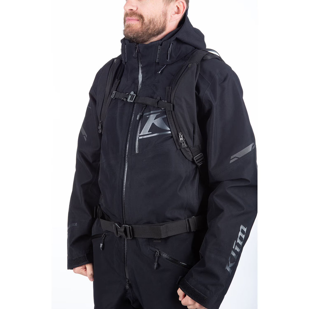 Person wearing a black Klim motorcycle jacket on a white background