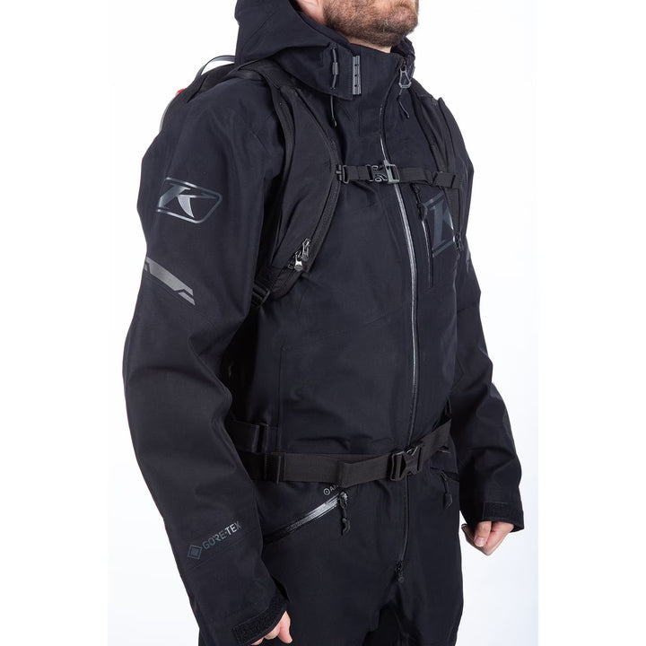 Person wearing a black jacket with a brand logo on a white background