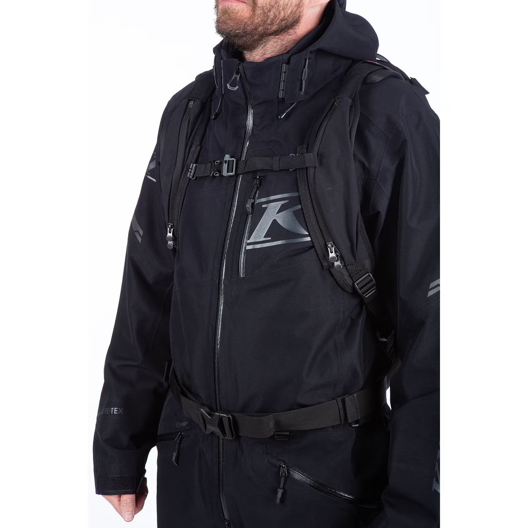 Person wearing a black jacket with a brand logo on a white background