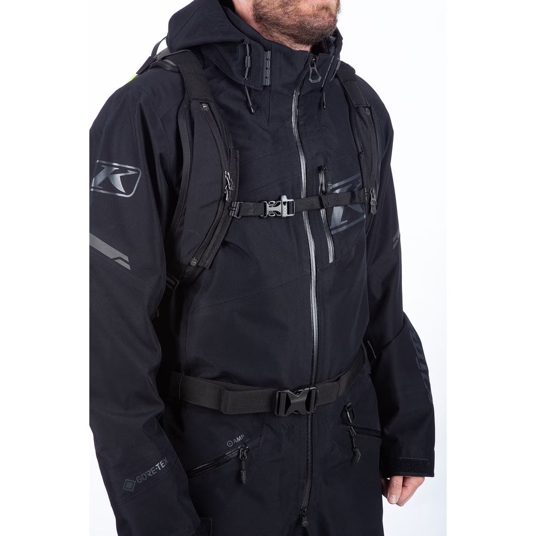 Person wearing a black jacket with a brand logo on a white background