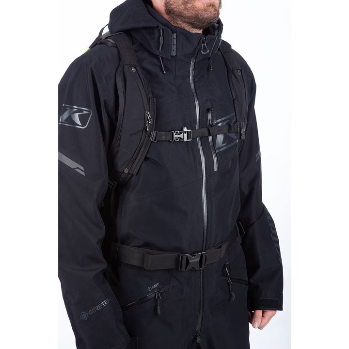 Person wearing a black jacket with a brand logo on a white background