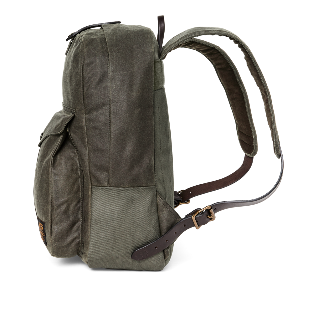 Green backpack with brown leather straps on a white background