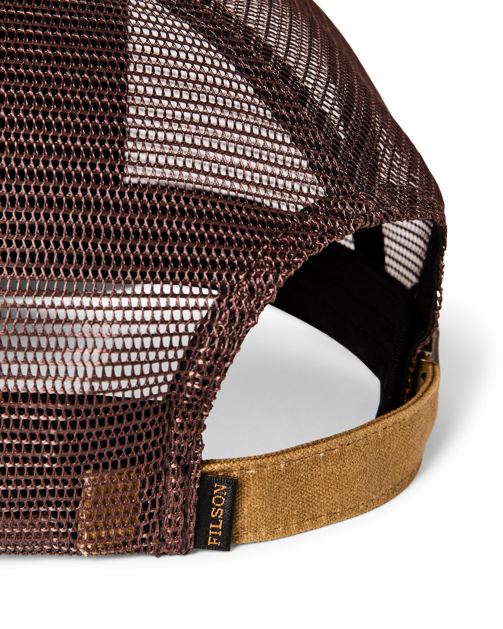 Close-up of the back of a Filson trucker cap showing a dark brown mesh back, a tan canvas underbrim, and a black adjustable strap with a visible Filson brand tag.