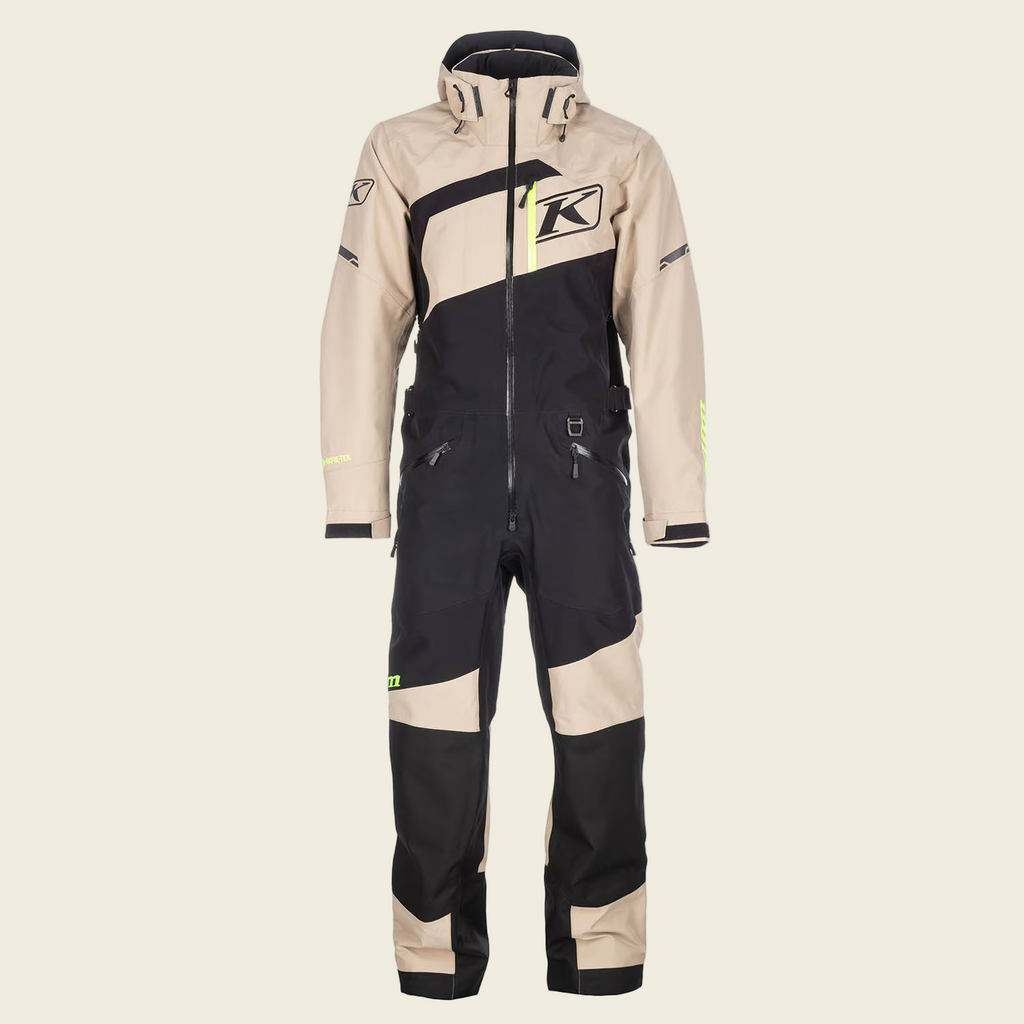 Beige and black snowmobile suit with Klim logo on a white background