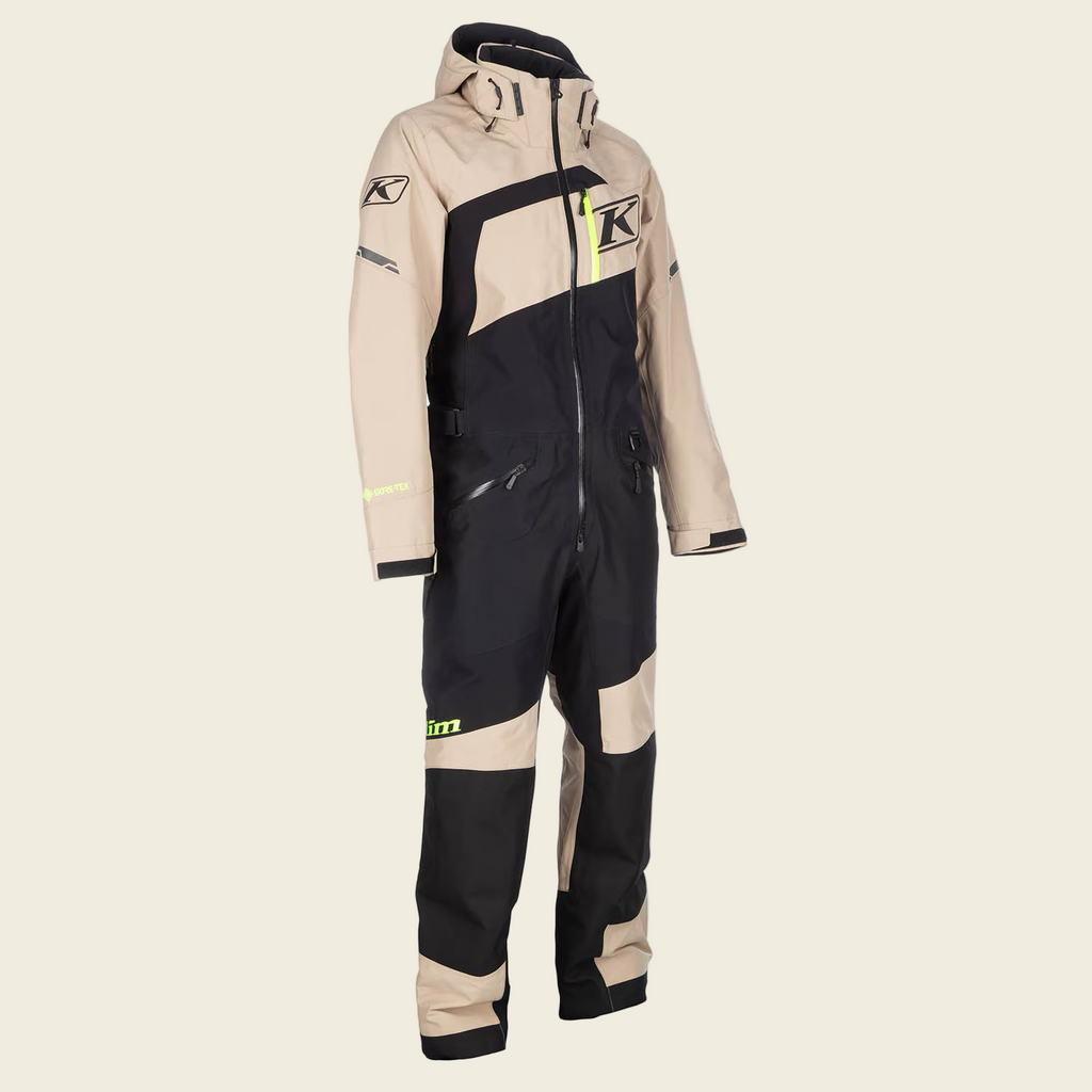 Beige and black snowmobile suit with Klim logo on a white background