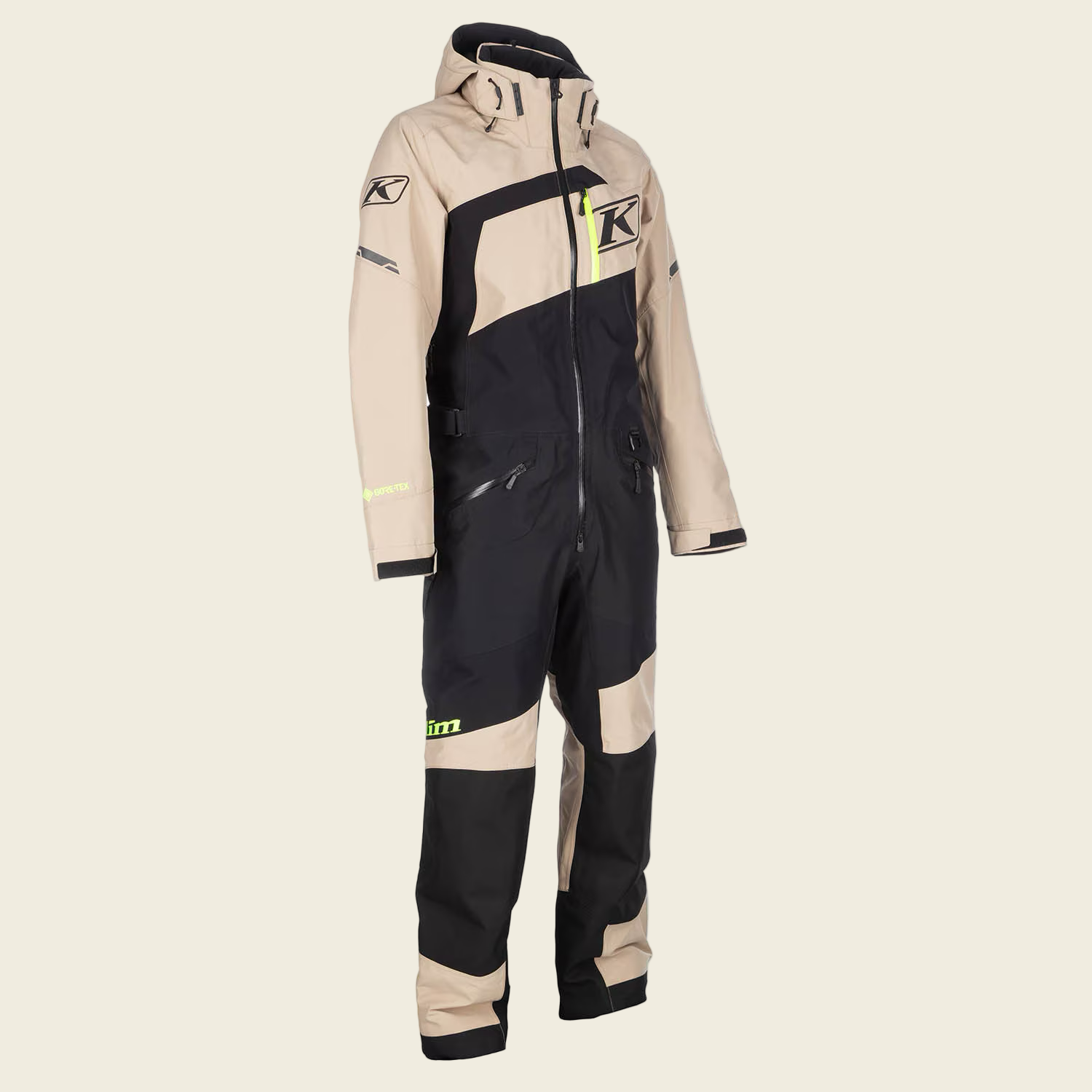 Beige and black snowmobile suit with Klim logo on a white background