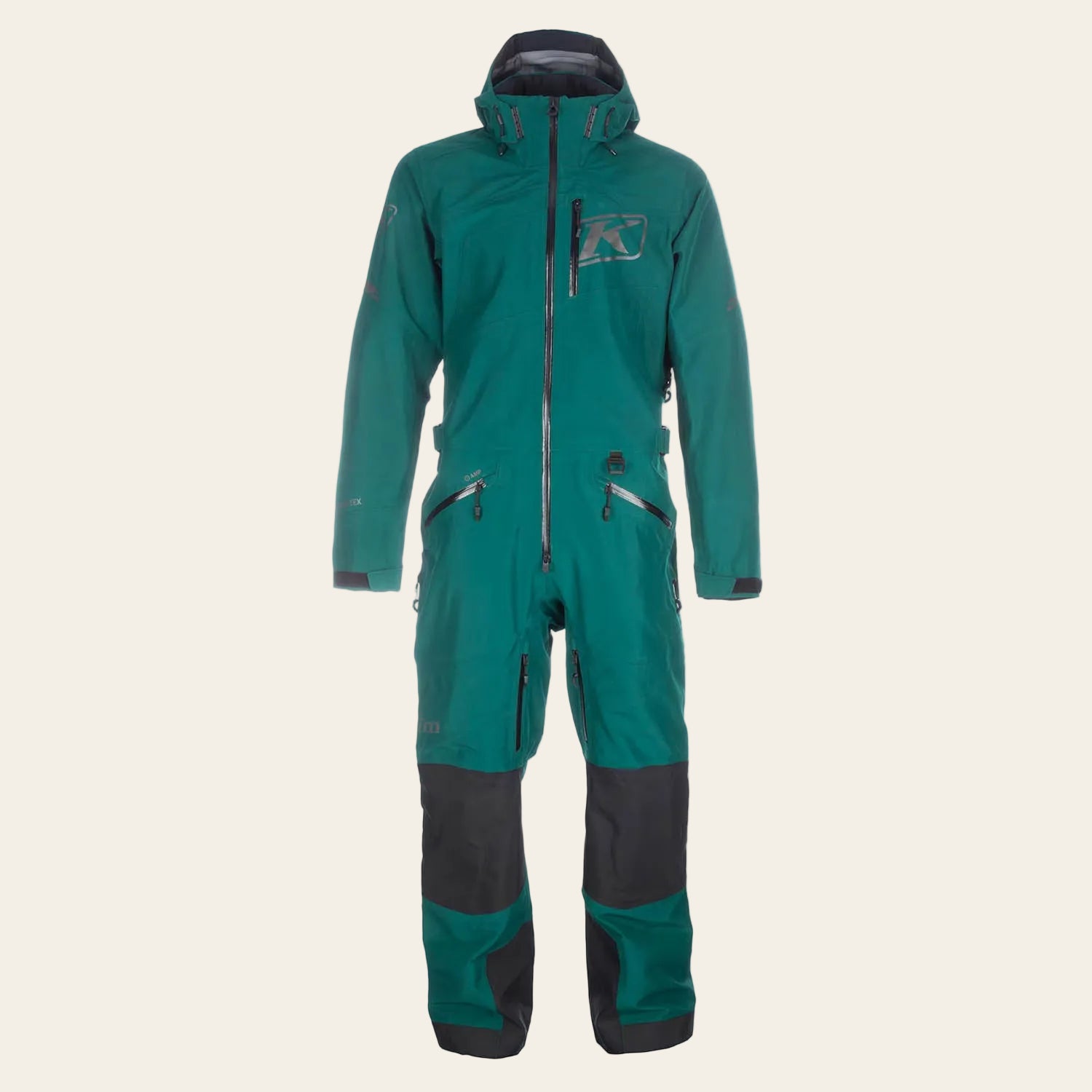 A teal green and dark gray full-body snowsuit shown flat against a solid white background. The suit features a hood, a full-length front zipper, multiple zippered pockets, and a small graphic logo on the left chest.