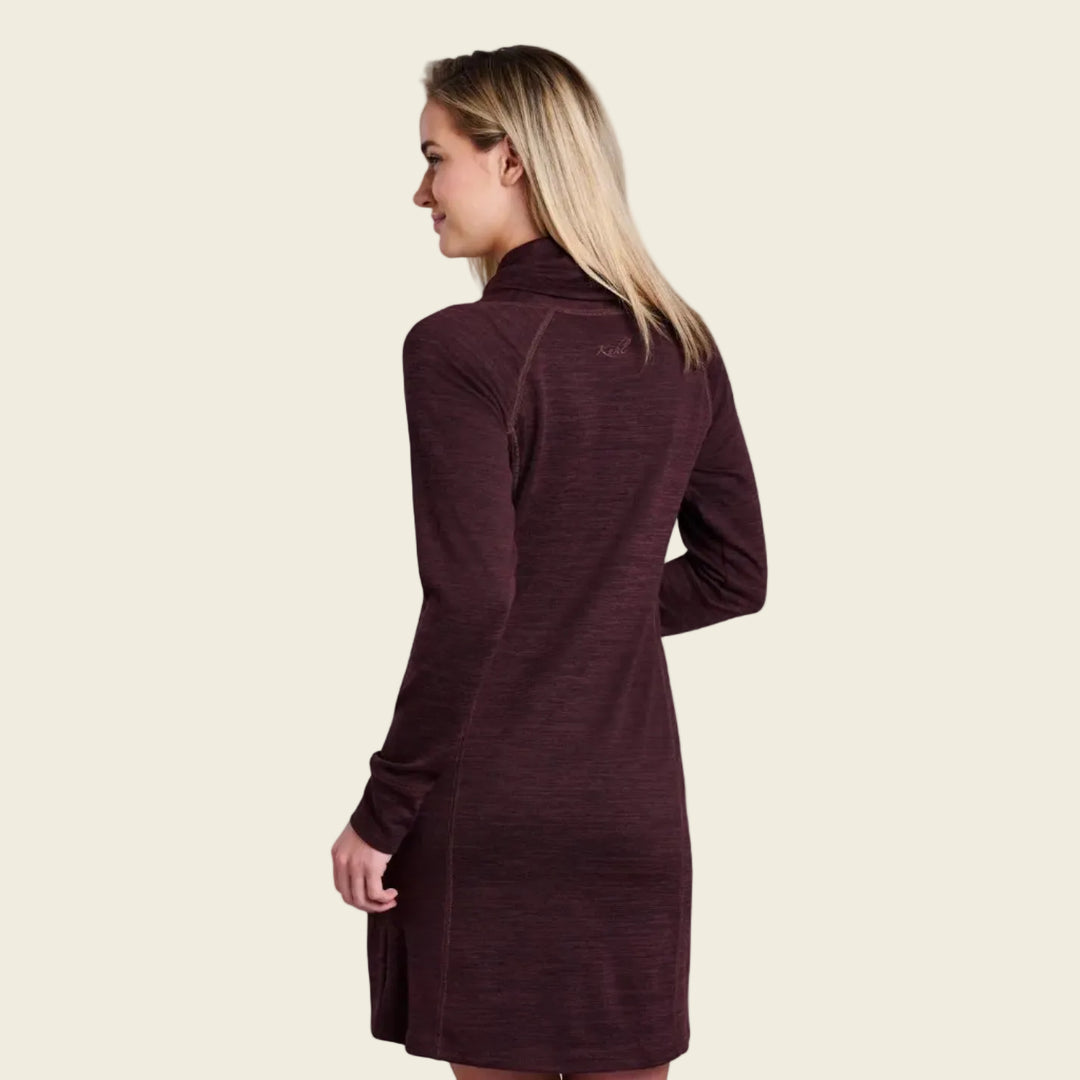 Woman wearing a long-sleeve brown dress on a white background