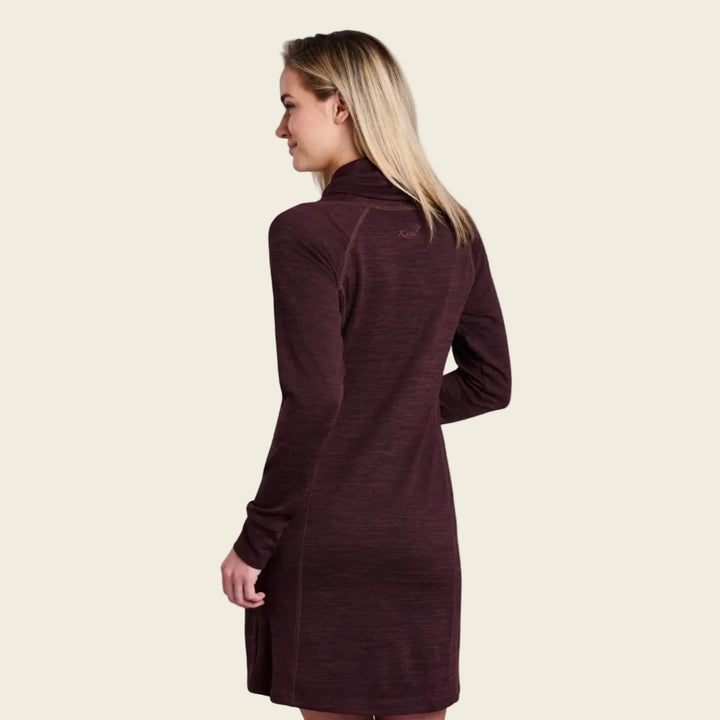 Woman wearing a long-sleeve brown dress on a white background