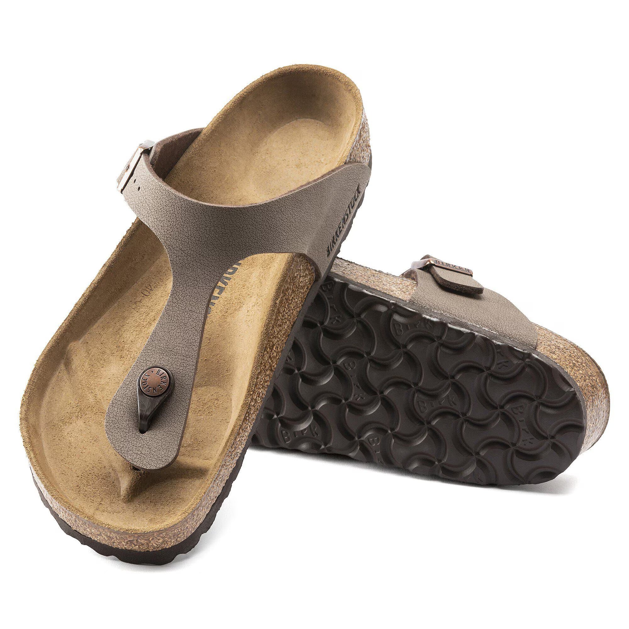 Pair of brown sandals with a textured sole on a white background