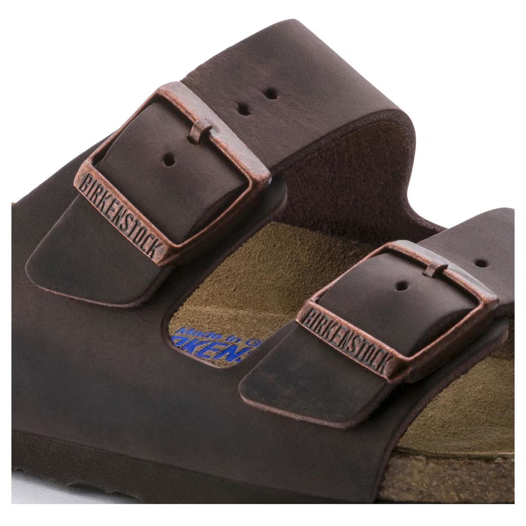 Brown Birkenstock sandals with leather straps on a white background