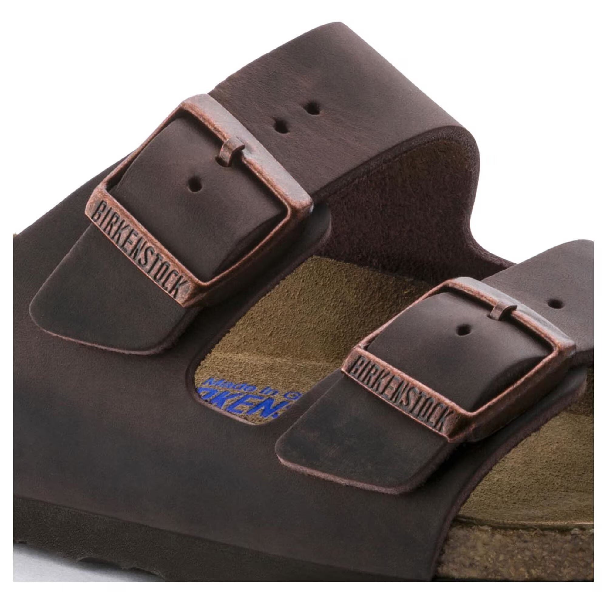 Brown Birkenstock sandals with leather straps on a white background