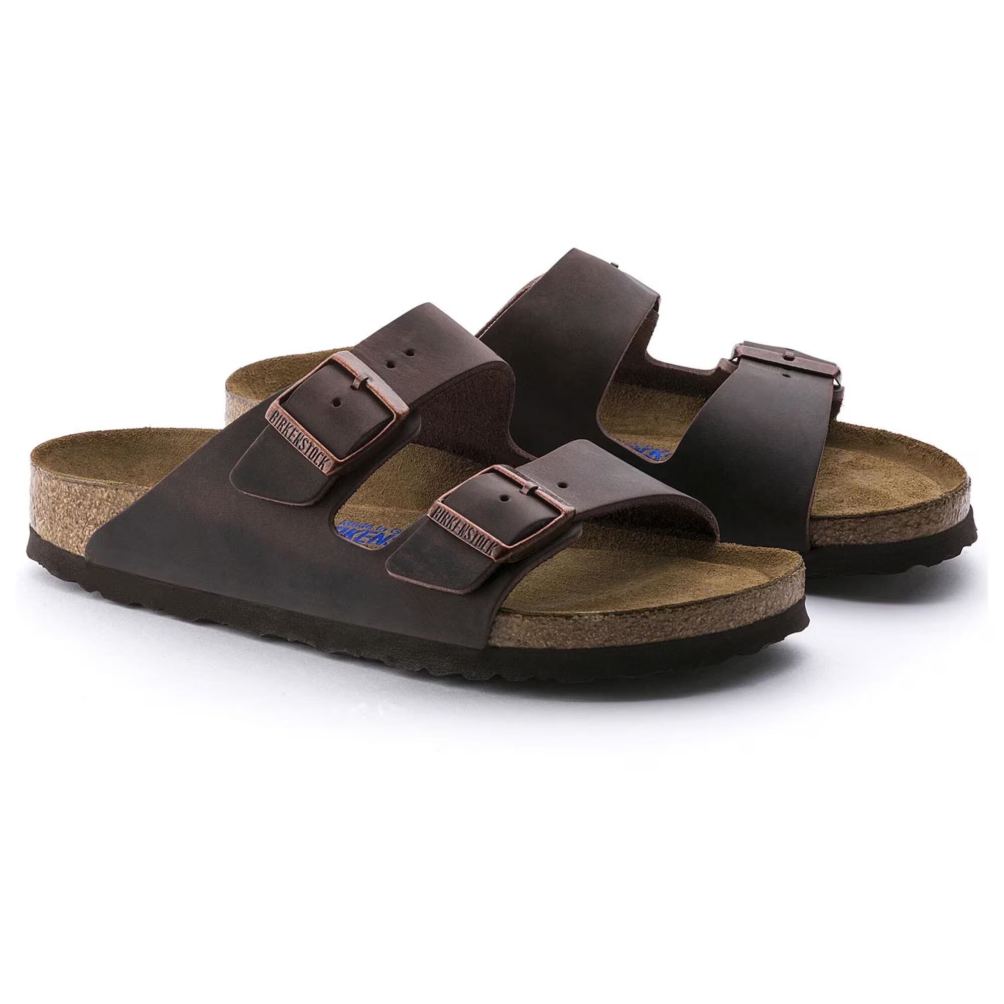 Pair of brown sandals with cork insole on a white background