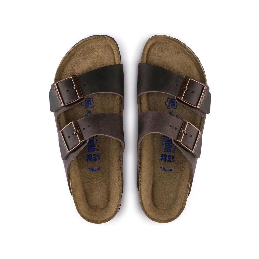Pair of brown sandals with double buckles on a white background