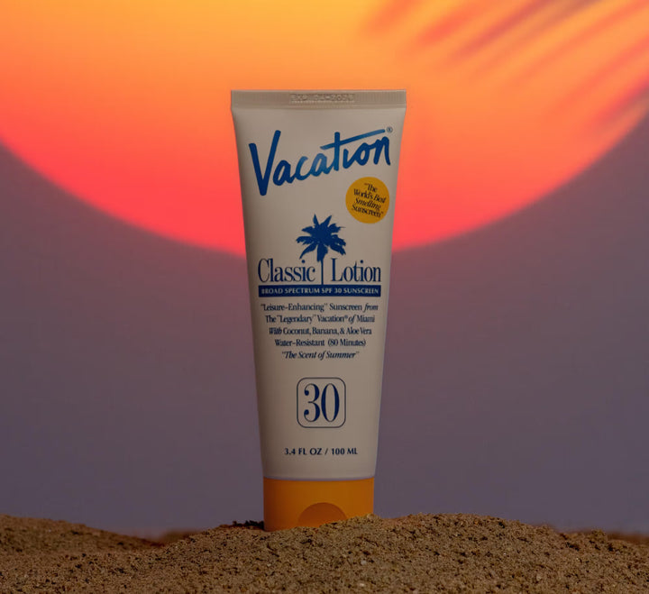 Sunscreen lotion tube labeled 'Vacation' on a sand-like textured background with a colorful gradient.