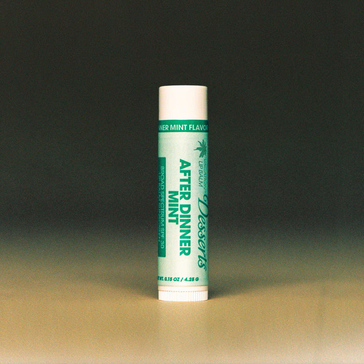 Lip balm tube with green label on a gradient background