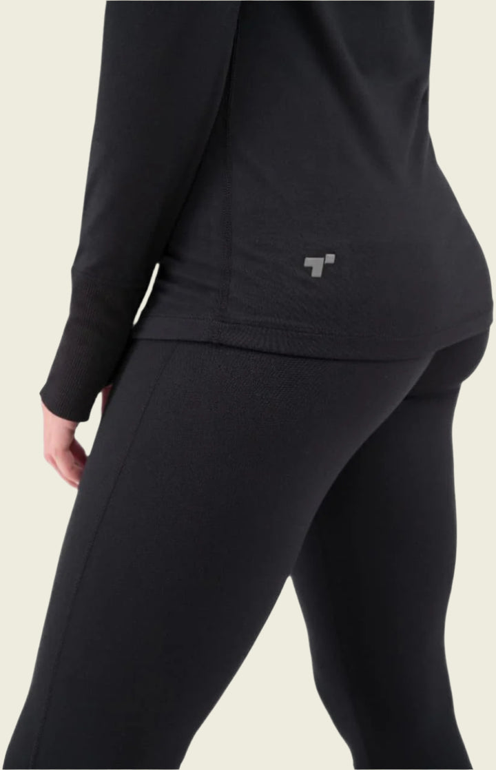 Person wearing a black outfit with a small logo on a white background