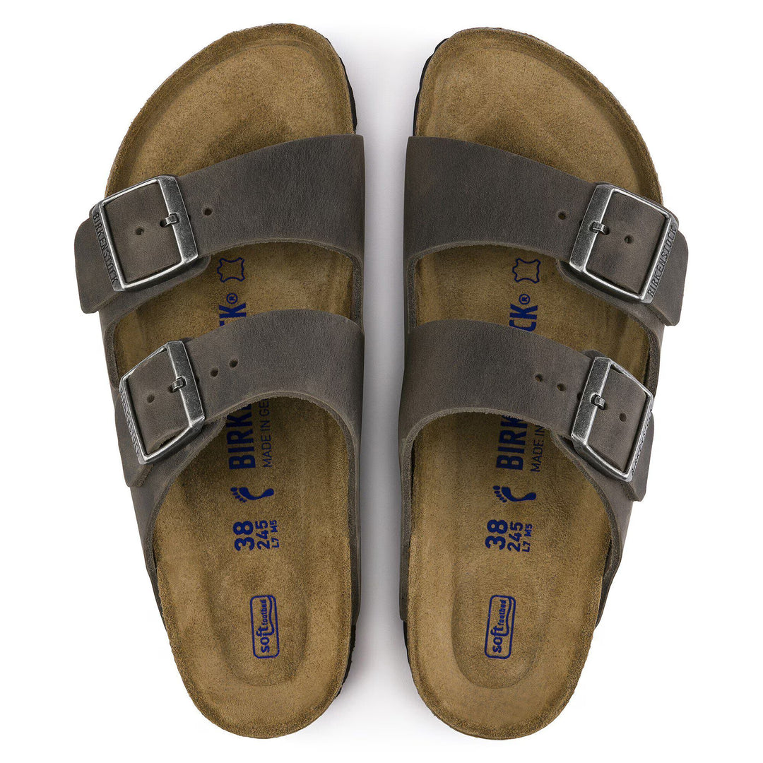 Pair of brown sandals with buckles on a white background