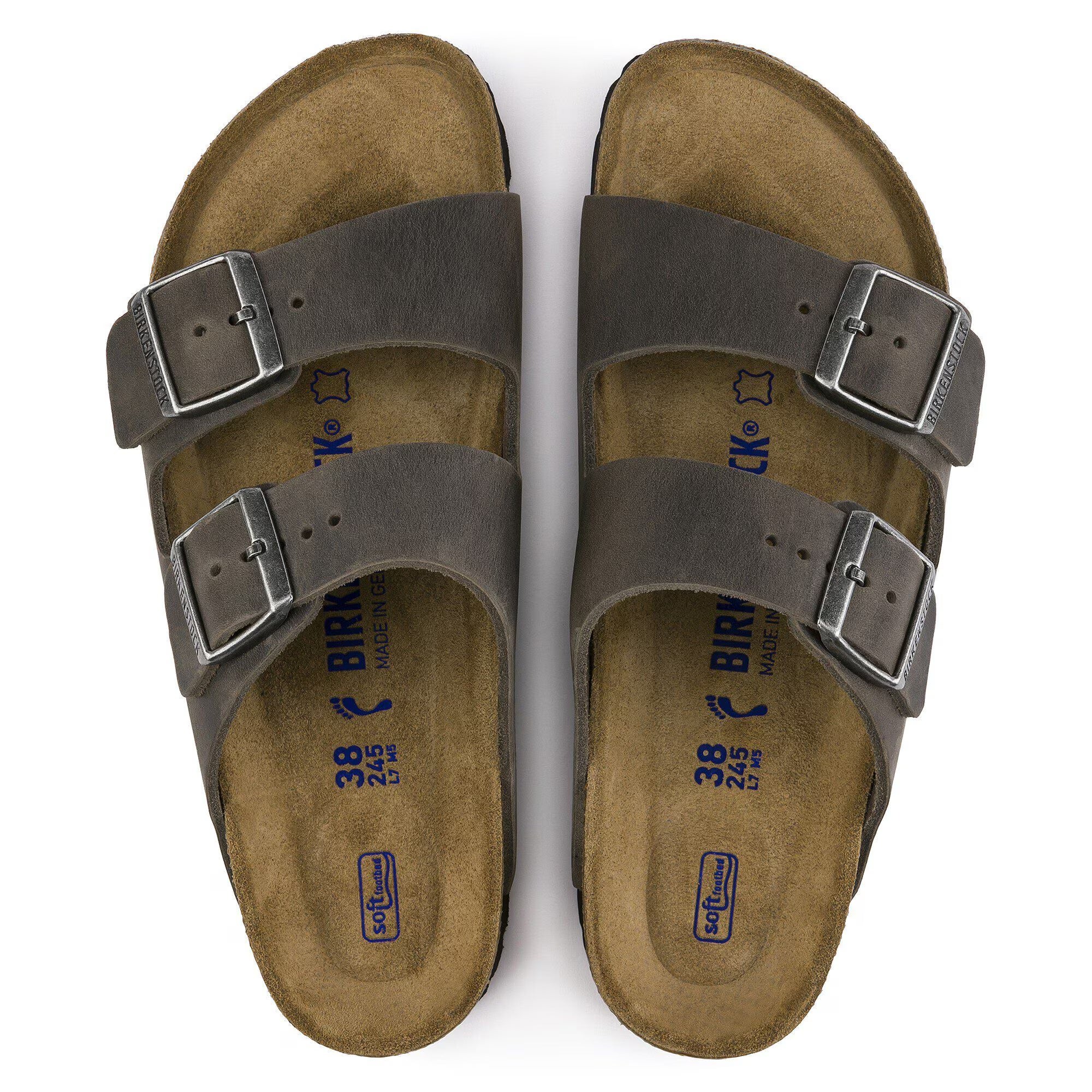 Pair of brown sandals with buckles on a white background