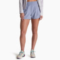 Person wearing light blue athletic shorts on a white background
