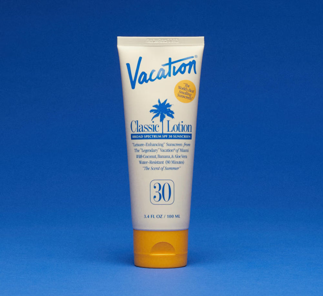 Tube of 'Vacation Classic Lotion' sunscreen on a blue background