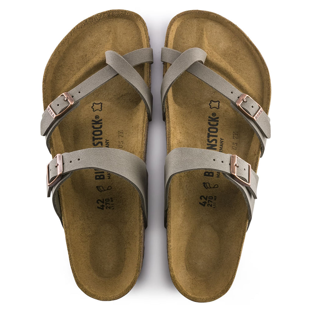 Pair of brown sandals with straps on a white background
