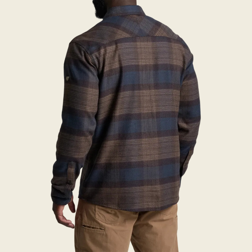 Person wearing a plaid shirt with a white background