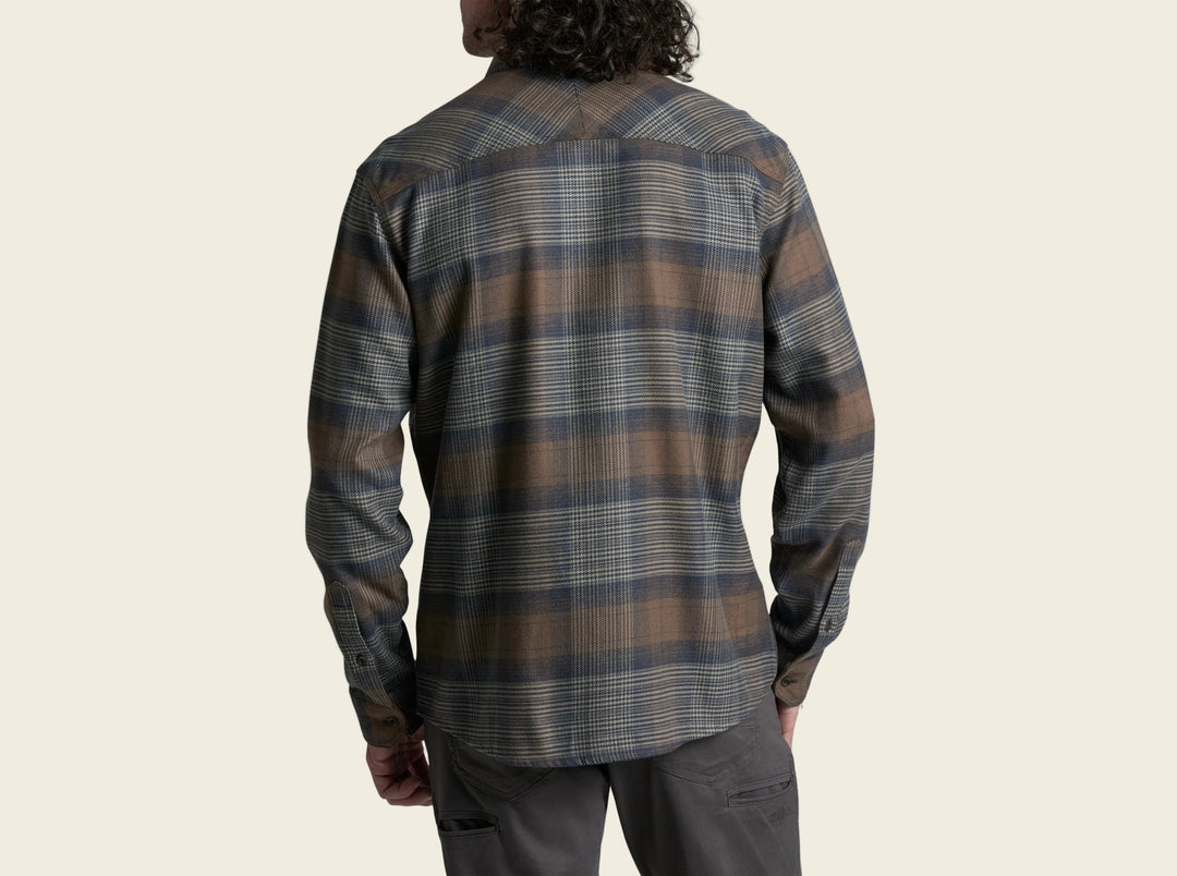 Person wearing a plaid shirt with a white background
