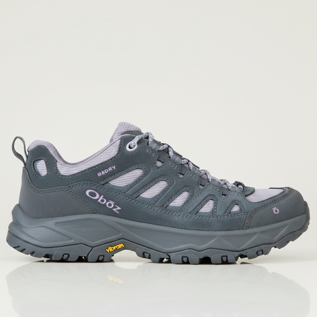 A single Oboz Badry hiking shoe in dark gray suede and mesh with light purple accents, featuring a Vibram sole, shown on a plain white background.