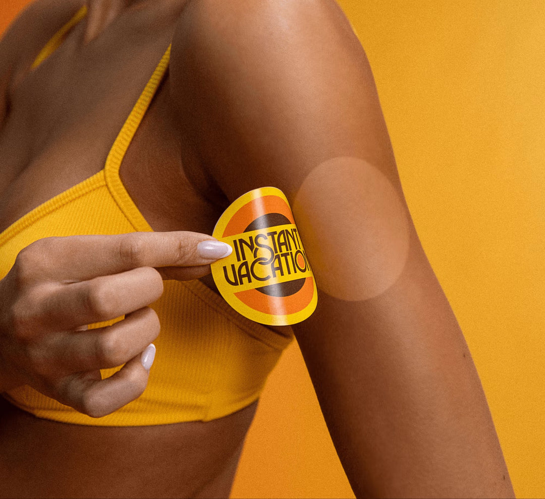 Person wearing a yellow bikini with a 'Instant Vacation' sun screen patch on an orange background